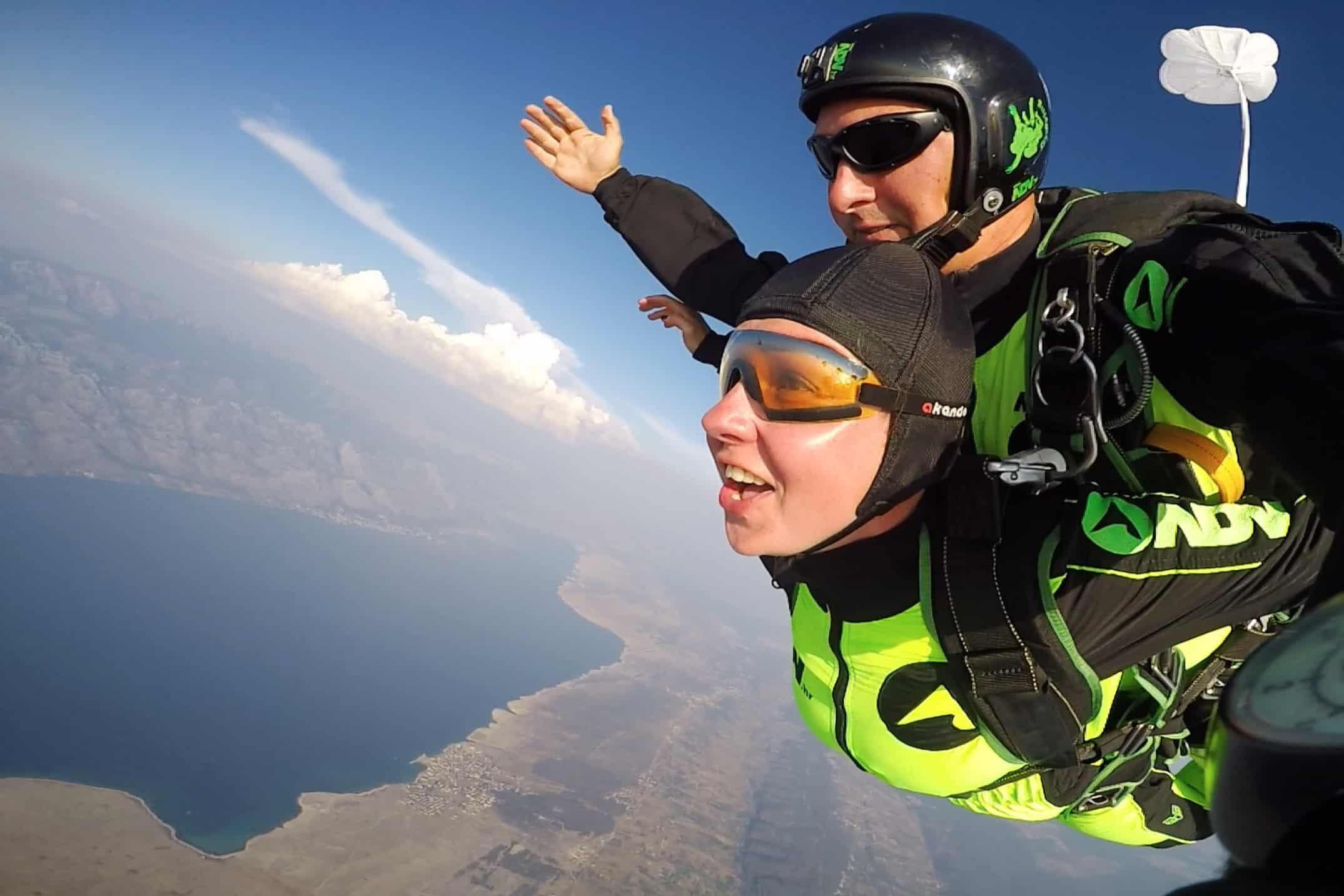 happy tandem skydiver in free fall